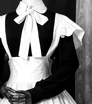 Close-up of a white bow collar on a black dress