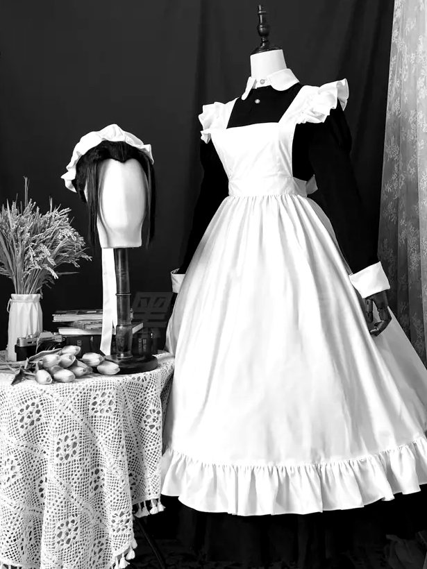 Plate No. I: black dress with winged shoulders and a full white apron, on a dress form